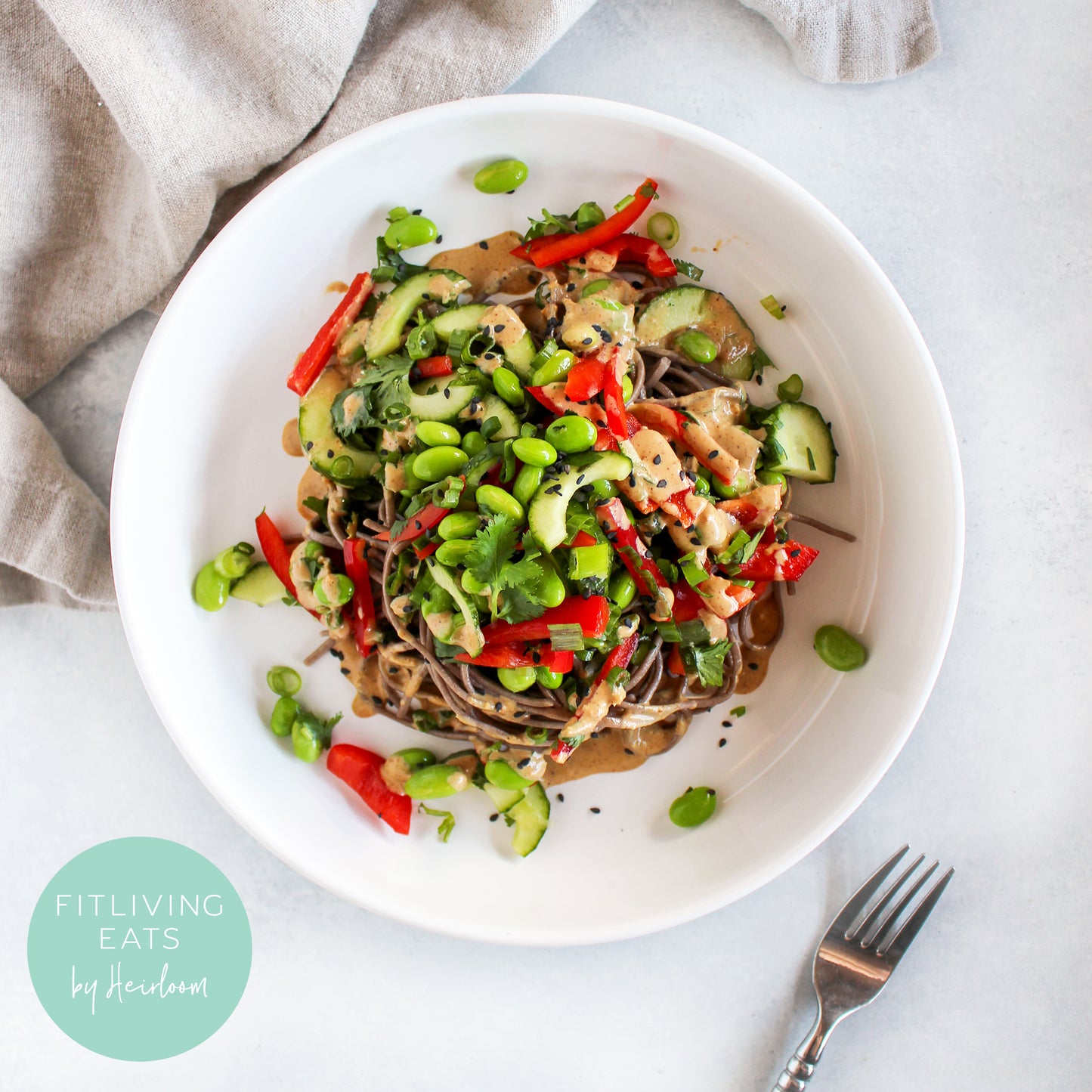 buckwheat soba noodles served chilled tossed in a soy-free thai almond sauce with red bell pepper, cucumber, edamame, scallion, and cilantro; healthy meal prep delivery 